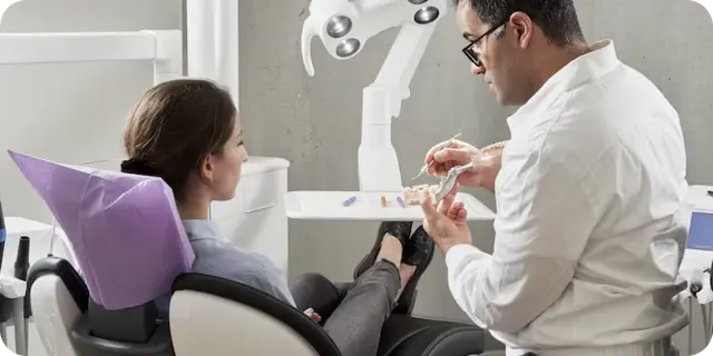 A Dentist discussing with patient concerning her new set of teeth
