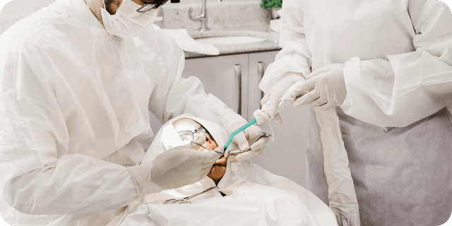 Dentists Operating on a tooth